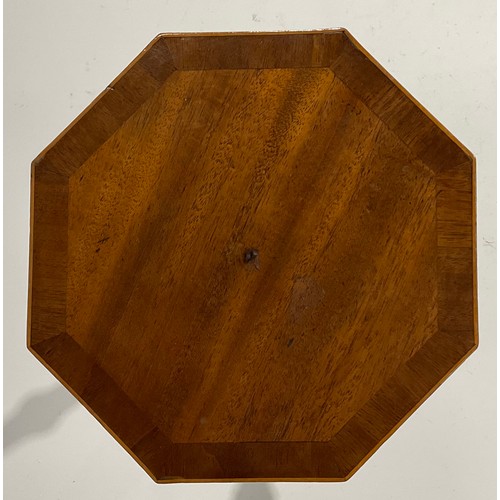 1696 - A 19th century mahogany octagonal candle stand, the cross banded top outlined with boxwood stringing... 