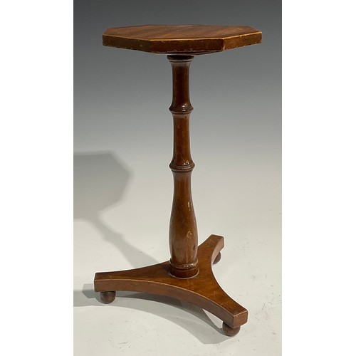 1696 - A 19th century mahogany octagonal candle stand, the cross banded top outlined with boxwood stringing... 