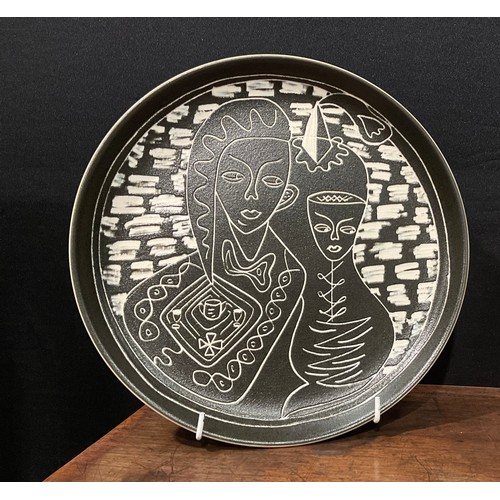 88 - A Denby Tibor Ware plate, Rendezvous, designed by Tibor Reich, sgraffito incised with a couple takin... 