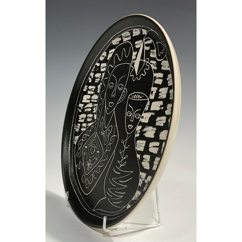 88 - A Denby Tibor Ware plate, Rendezvous, designed by Tibor Reich, sgraffito incised with a couple takin... 