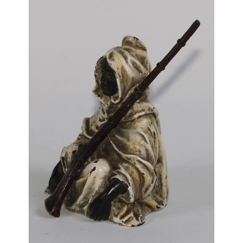 1680 - A cold painted bronze, of an Arab seated with a jezzail, 12cm high