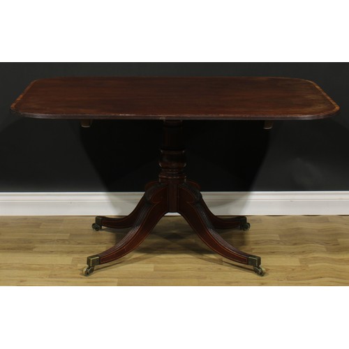 2370 - A Regency tulipwood crossbanded mahogany centre table, rounded rectangular tilting top, turned colum... 