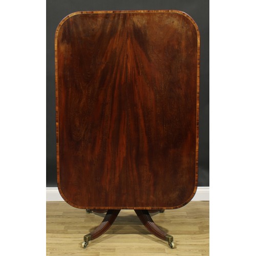 2370 - A Regency tulipwood crossbanded mahogany centre table, rounded rectangular tilting top, turned colum... 