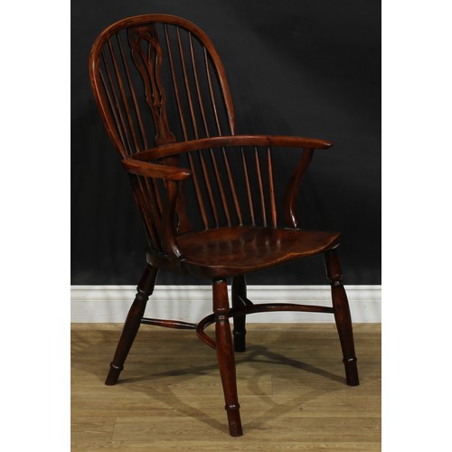 1642 - A 19th century yew and beech Windsor elbow chair, hoop back, shaped and pierced splat, one-piece mid... 