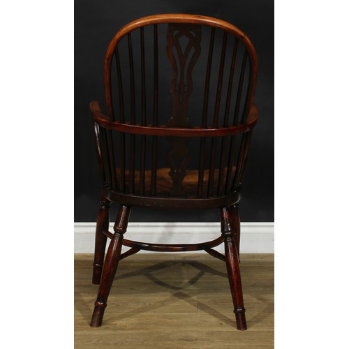 1642 - A 19th century yew and beech Windsor elbow chair, hoop back, shaped and pierced splat, one-piece mid... 