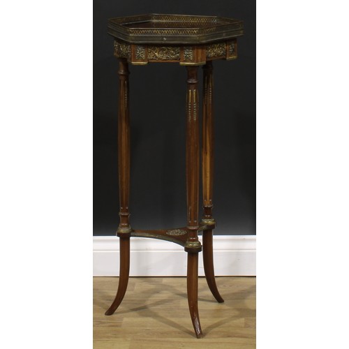 1967 - A Louis XVI Revival gilt metal mounted mahogany urn stand, hexagonal top with pierced gallery, flute... 