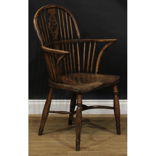 1722 - A country house beech, ash and elm star-back Windsor elbow chair, hoop back, shaped and pierced spla... 