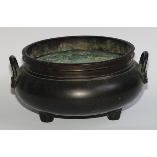 422 - A large Chinese dark patinated bronze tripod censer, loop handles, 32cm wide