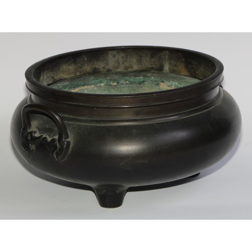 422 - A large Chinese dark patinated bronze tripod censer, loop handles, 32cm wide