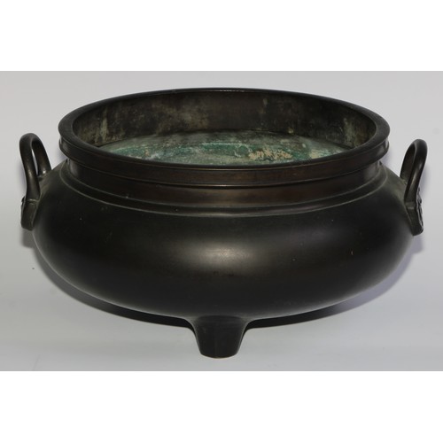 422 - A large Chinese dark patinated bronze tripod censer, loop handles, 32cm wide