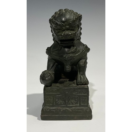 462 - Chinese School, a verdigris patinated bronze, of a temple guardian lion, rectangular base, 18.5cm hi... 