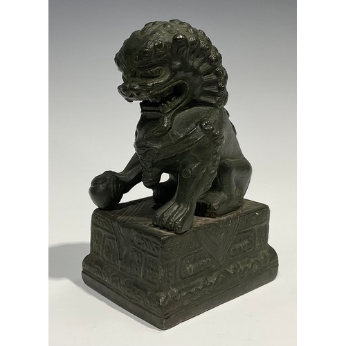 462 - Chinese School, a verdigris patinated bronze, of a temple guardian lion, rectangular base, 18.5cm hi... 