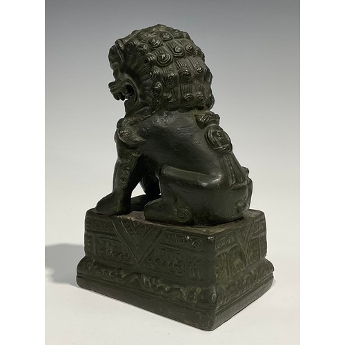 462 - Chinese School, a verdigris patinated bronze, of a temple guardian lion, rectangular base, 18.5cm hi... 