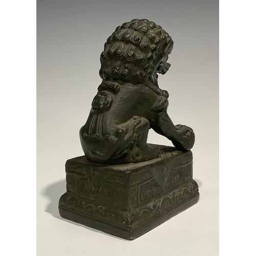 462 - Chinese School, a verdigris patinated bronze, of a temple guardian lion, rectangular base, 18.5cm hi... 