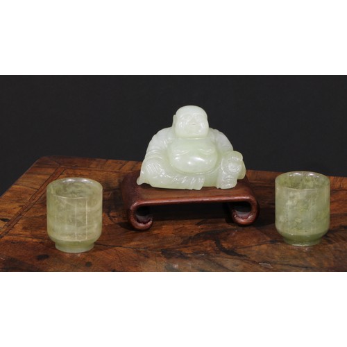 382 - A Chinese jade carving, of Budai, he sits, rotund, holding beads, 10cm wide, hardwood stand; a pair ... 