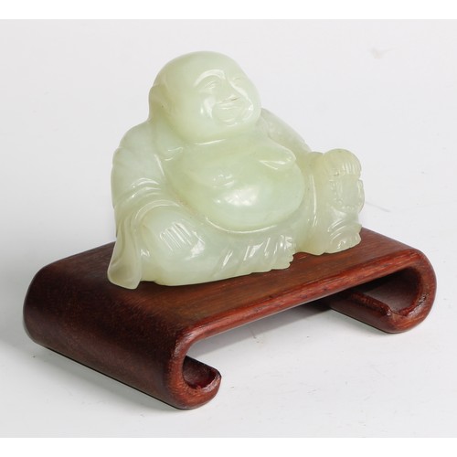 382 - A Chinese jade carving, of Budai, he sits, rotund, holding beads, 10cm wide, hardwood stand; a pair ... 