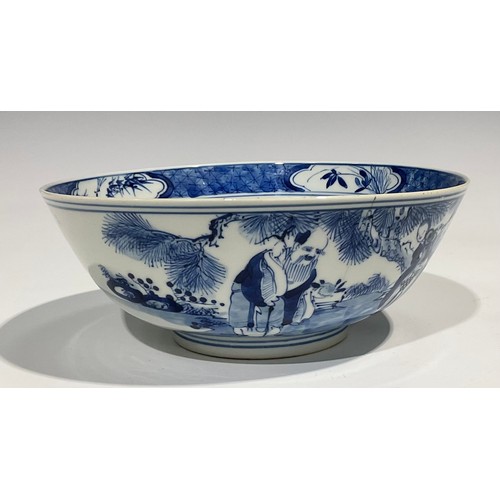 359 - A Chinese circular bowl, playing in tones of underglaze blue with figures in a monumental landscape,... 