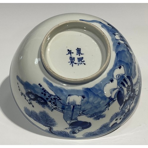 359 - A Chinese circular bowl, playing in tones of underglaze blue with figures in a monumental landscape,... 