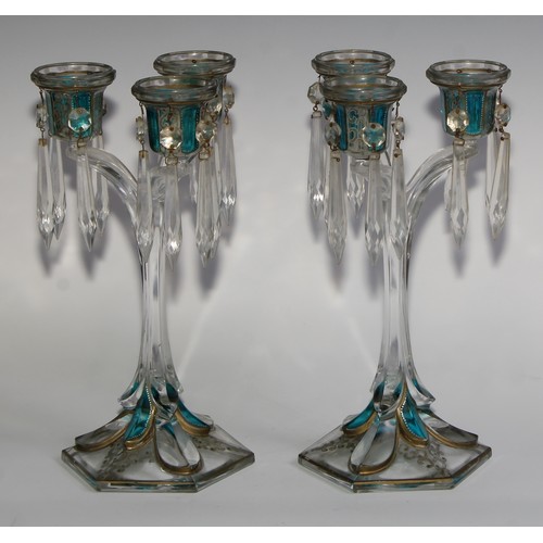 322 - A pair of 19th century pressed glass three-light candle lustres, with blue-flash panels picked out w... 