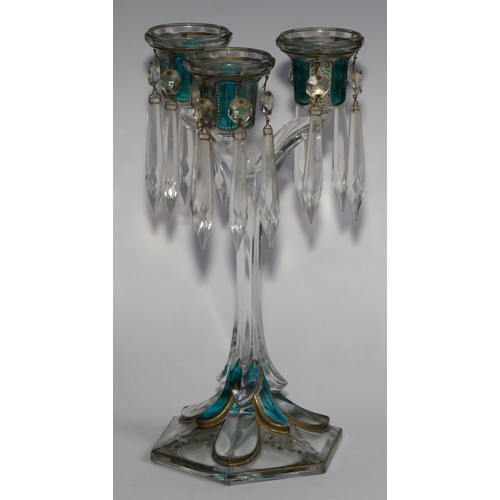 322 - A pair of 19th century pressed glass three-light candle lustres, with blue-flash panels picked out w... 