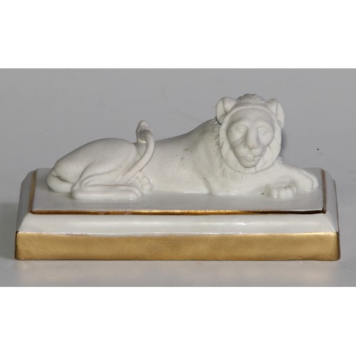 289 - A Dagoty porcelain model, of a recumbent lion, in the white with gilt borders, 11cm wide, red mark, ... 