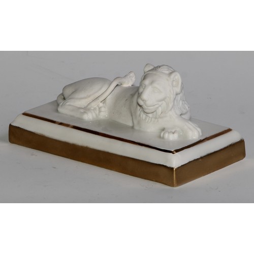 289 - A Dagoty porcelain model, of a recumbent lion, in the white with gilt borders, 11cm wide, red mark, ... 