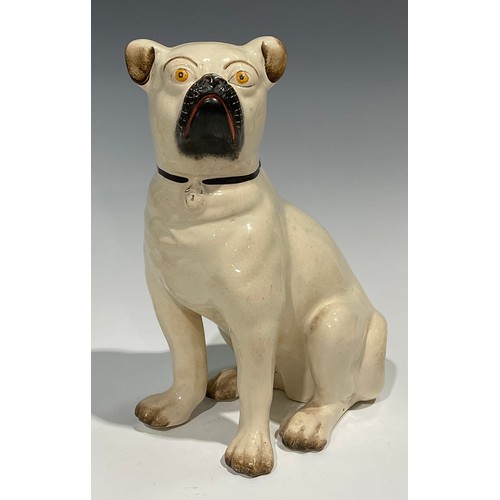 96 - A pair of 19th century Staffordshire models of pugs, seated to left and right, painted features, 28c... 