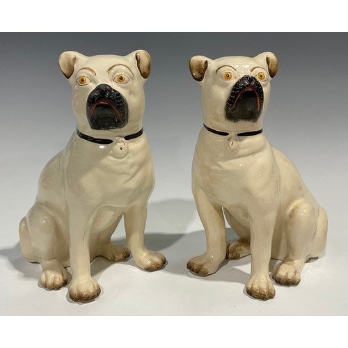 96 - A pair of 19th century Staffordshire models of pugs, seated to left and right, painted features, 28c... 