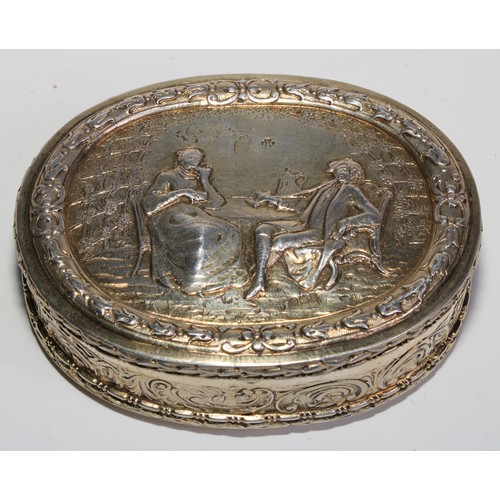 1144 - An early 20th century Dutch silver-gilt oval table snuff box, chased with topers and their wives, th... 