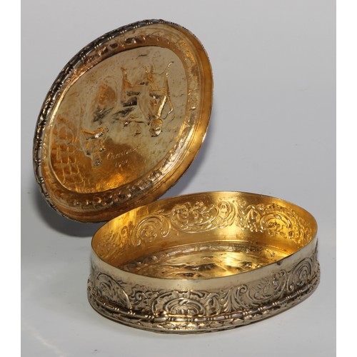 1144 - An early 20th century Dutch silver-gilt oval table snuff box, chased with topers and their wives, th... 