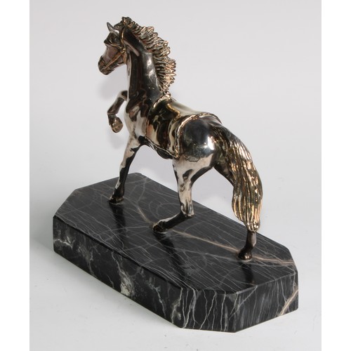 870 - A Continental parcel-gilt silver coloured metal model, of a horse, prancing, filled, canted rectangu... 