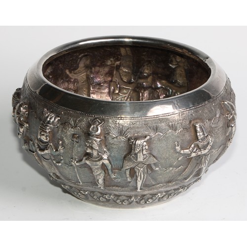 858 - A Burmese silver circular bowl, interestingly repousse chased with a meeting between Assyrian and In... 