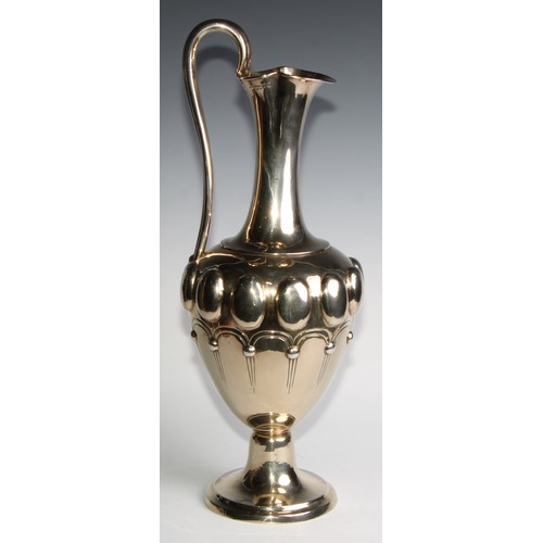 998 - A large Victorian silver-gilt pedestal ewer, in the Renaissance Revival taste, chased with a band of... 