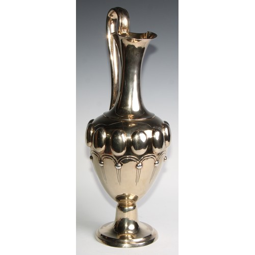 998 - A large Victorian silver-gilt pedestal ewer, in the Renaissance Revival taste, chased with a band of... 