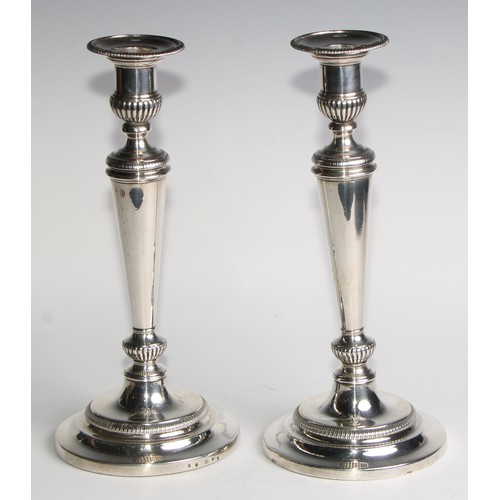 1223 - Matthew Boulton - a pair of George III silver table candlesticks, half-fluted campana sconces with d... 