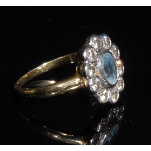 1498 - An aquamarine and diamond cluster ring, central oval pale blue aquamarine, approx 0.65ct, surrounded... 