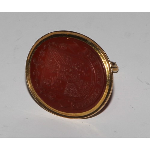 2141 - A 19th century gold coloured metal seal fob, the carnelian matrix with armorial intaglio, 3cm wide