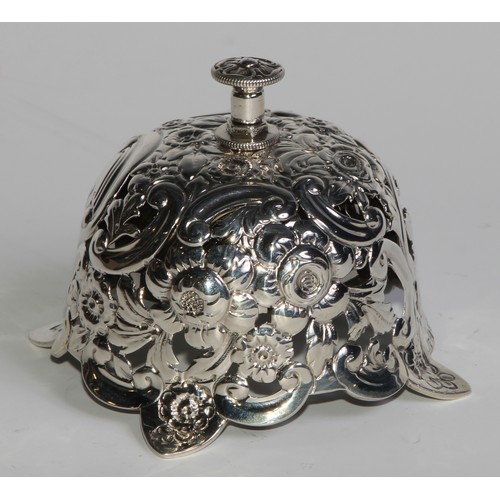 1090 - A Victorian silver desk or counter bell, pierced and profusely chased with flowers and scrolling fol... 