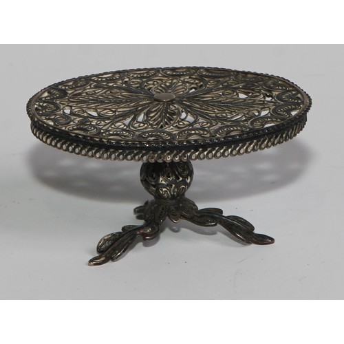 878 - A Continental silver filigree miniature oval tripod centre table, 4.5cm wide, early 20th century