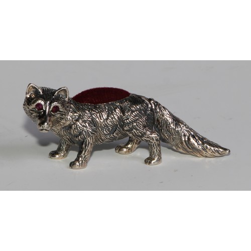 1075 - A sterling silver novelty pin cushion, as a fox, ruby eyes, 6cm long