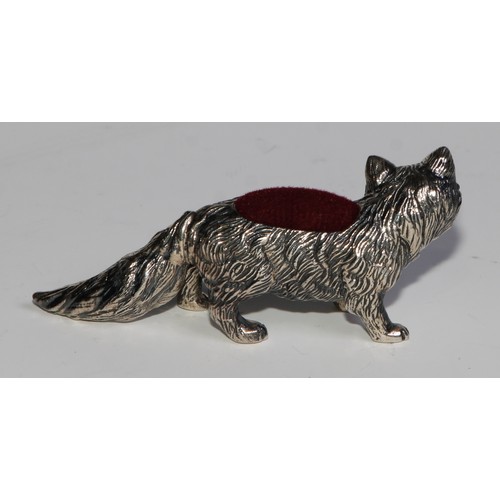 1075 - A sterling silver novelty pin cushion, as a fox, ruby eyes, 6cm long