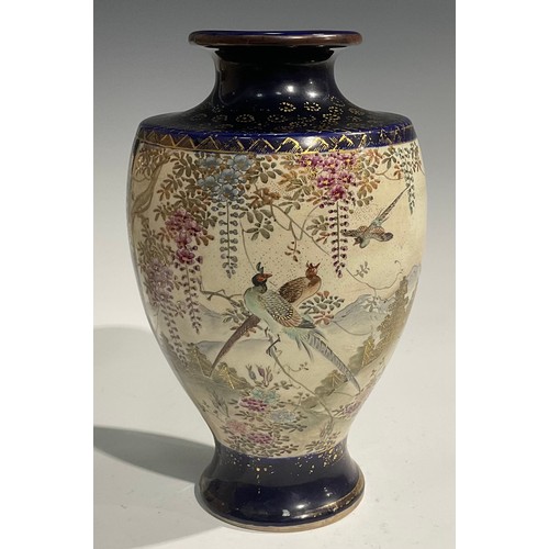 473 - A pair of Japanese satsuma baluster vases, decorated with traditional landscape and bird panels, blu... 