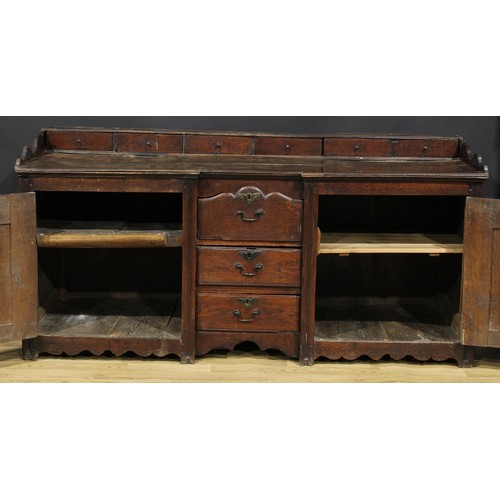 2004 - An 18th century oak low dresser, rectangular top with six small drawers above a pair of raised and f... 