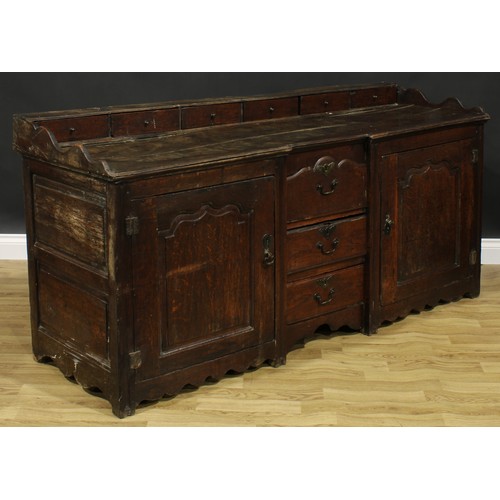 2004 - An 18th century oak low dresser, rectangular top with six small drawers above a pair of raised and f... 