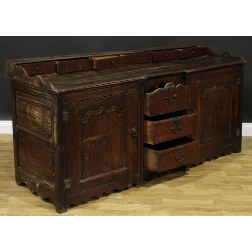 2004 - An 18th century oak low dresser, rectangular top with six small drawers above a pair of raised and f... 