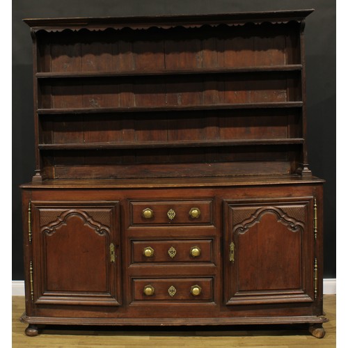 2329 - An early 19th century North European oak dresser, moulded cornice above three plate rack shelves, th... 