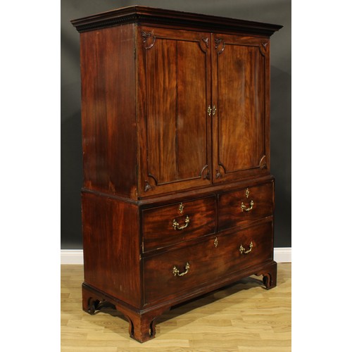 1633 - A 19th century mahogany linen press, outswept cornice with meandrous capital above a pair of panel d... 