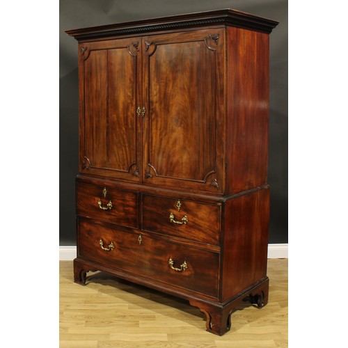 1633 - A 19th century mahogany linen press, outswept cornice with meandrous capital above a pair of panel d... 