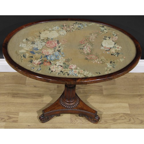 2618 - A William IV rosewood and mahogany low occasional table, oval top with glazed needlework panel, turn... 