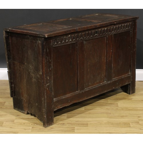 1569 - A 17th century oak blanket chest, hinged top, nulled frieze, three panel front, 74cm high, 115cm wid... 